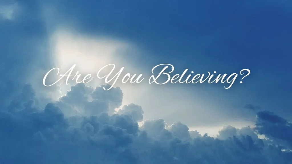 Sunlight breaking through dark blue clouds with the words Are You Believing in white script.